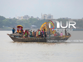 An idol of Goddess Durga is ferried to the middle of the river Ganges for immersion on the last day of the Durga Puja festival in Kolkata, I...