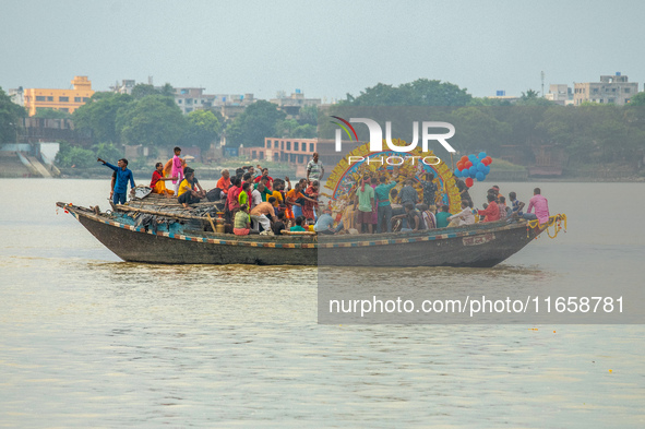 An idol of Goddess Durga is ferried to the middle of the river Ganges for immersion on the last day of the Durga Puja festival in Kolkata, I...