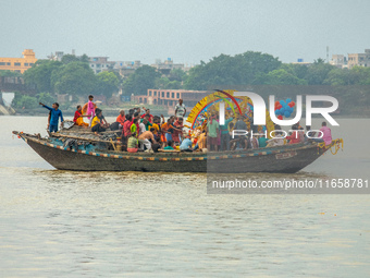 An idol of Goddess Durga is ferried to the middle of the river Ganges for immersion on the last day of the Durga Puja festival in Kolkata, I...