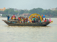 An idol of Goddess Durga is ferried to the middle of the river Ganges for immersion on the last day of the Durga Puja festival in Kolkata, I...