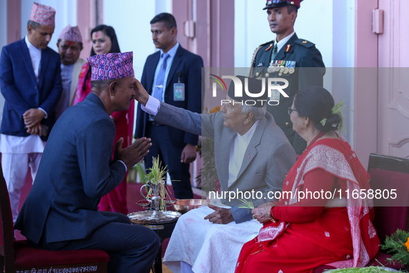 Nepal President Ram Chandra Paudel (in black cap) offers ''Tika'' to a member of the public at the Presidential palace in Kathmandu, Nepal,...