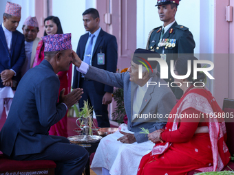 Nepal President Ram Chandra Paudel (in black cap) offers ''Tika'' to a member of the public at the Presidential palace in Kathmandu, Nepal,...