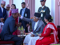 Nepal President Ram Chandra Paudel (in black cap) offers ''Tika'' to a member of the public at the Presidential palace in Kathmandu, Nepal,...