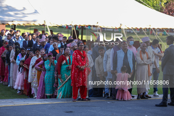 People stand in a queue on the premises of the Presidential Palace in Kathmandu, Nepal, on October 12, 2024, to receive ''Tika'' from Nepali...