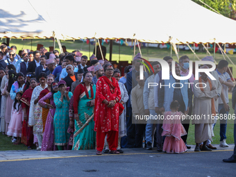 People stand in a queue on the premises of the Presidential Palace in Kathmandu, Nepal, on October 12, 2024, to receive ''Tika'' from Nepali...