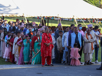 People stand in a queue on the premises of the Presidential Palace in Kathmandu, Nepal, on October 12, 2024, to receive ''Tika'' from Nepali...