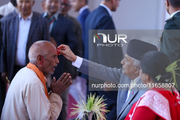 Nepal President Ram Chandra Paudel (in black cap) offers ''Tika'' to a member of the public at the Presidential palace in Kathmandu, Nepal,...