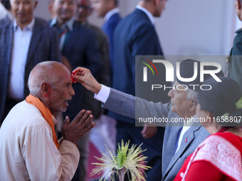 Nepal President Ram Chandra Paudel (in black cap) offers ''Tika'' to a member of the public at the Presidential palace in Kathmandu, Nepal,...