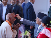 Nepal President Ram Chandra Paudel (in black cap) offers ''Tika'' to a member of the public at the Presidential palace in Kathmandu, Nepal,...