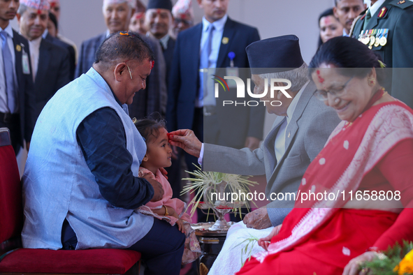 Nepal President Ram Chandra Paudel (in black cap) offers ''Tika'' to a member of the public at the Presidential palace in Kathmandu, Nepal,...