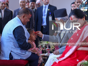 Nepal President Ram Chandra Paudel (in black cap) offers ''Tika'' to a member of the public at the Presidential palace in Kathmandu, Nepal,...