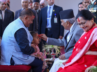 Nepal President Ram Chandra Paudel (in black cap) offers ''Tika'' to a member of the public at the Presidential palace in Kathmandu, Nepal,...