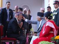 Nepal President Ram Chandra Paudel (in black cap) offers ''Tika'' to a member of the public at the Presidential palace in Kathmandu, Nepal,...