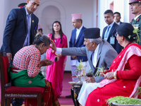 Nepal President Ram Chandra Paudel (in black cap) offers ''Tika'' to a member of the public at the Presidential palace in Kathmandu, Nepal,...