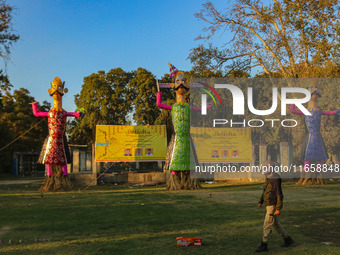 An Indian policeman walks near the effigies of the mythic demon king Ravana, his son Meghnath, and brother Kumbhkaran on the occasion of the...