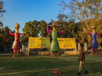 An Indian policeman walks near the effigies of the mythic demon king Ravana, his son Meghnath, and brother Kumbhkaran on the occasion of the...