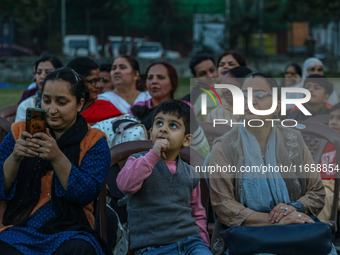 Hindu devotees look at the effigies of the mythic demon king Ravana, his son Meghnath, and brother Kumbhkaran on the occasion of the Hindu f...