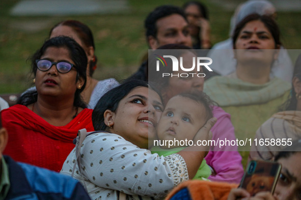 Hindu devotees look at the effigies of the mythic demon king Ravana, his son Meghnath, and brother Kumbhkaran on the occasion of the Hindu f...