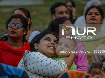 Hindu devotees look at the effigies of the mythic demon king Ravana, his son Meghnath, and brother Kumbhkaran on the occasion of the Hindu f...