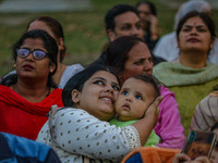 Hindu devotees look at the effigies of the mythic demon king Ravana, his son Meghnath, and brother Kumbhkaran on the occasion of the Hindu f...