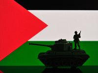 Illustration with figures of a soldier and a tank in front of a Palestine flag displayed on a computer screen is seen in L'Aquila, Italy, on...