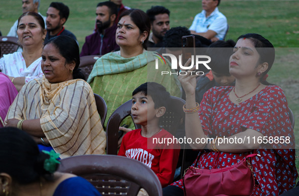 Hindu devotees look at the effigies of the mythic demon king Ravana, his son Meghnath, and brother Kumbhkaran on the occasion of the Hindu f...