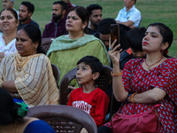 Hindu devotees look at the effigies of the mythic demon king Ravana, his son Meghnath, and brother Kumbhkaran on the occasion of the Hindu f...