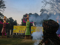 An Indian Paramilitary soldier looks at the effigies of the mythic demon king Ravana, his son Meghnath, and brother Kumbhkaran on the occasi...