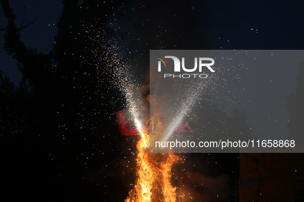 Fireworks explode as an effigy of Meghnad, son of demon king Ravana, burns on the occasion of the Hindu festival of Dussehra, which marks th...