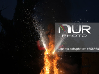 Fireworks explode as an effigy of Meghnad, son of demon king Ravana, burns on the occasion of the Hindu festival of Dussehra, which marks th...