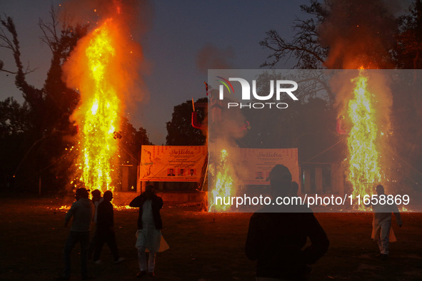 Effigies of the mythic demon king Ravana, his son Meghnath, and brother Kumbhkaran burn on the occasion of the Hindu festival of Dussehra, w...