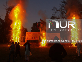 Effigies of the mythic demon king Ravana, his son Meghnath, and brother Kumbhkaran burn on the occasion of the Hindu festival of Dussehra, w...