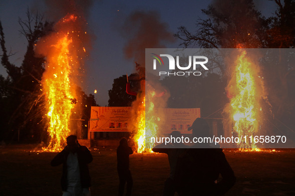 Effigies of the mythic demon king Ravana, his son Meghnath, and brother Kumbhkaran burn on the occasion of the Hindu festival of Dussehra, w...