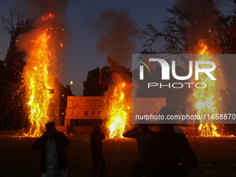 Effigies of the mythic demon king Ravana, his son Meghnath, and brother Kumbhkaran burn on the occasion of the Hindu festival of Dussehra, w...