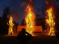 Effigies of the mythic demon king Ravana, his son Meghnath, and brother Kumbhkaran burn on the occasion of the Hindu festival of Dussehra, w...