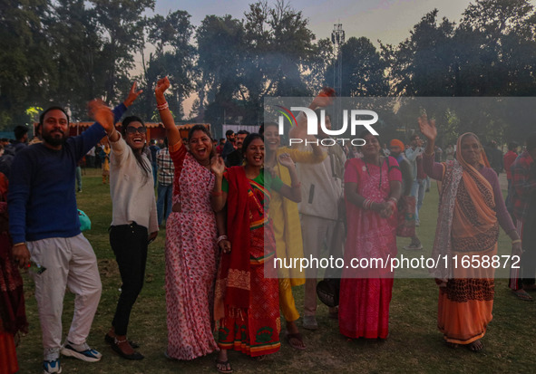 Hindu devotees dance as effigies of the mythic demon king Ravana, his son Meghnath, and brother Kumbhkaran burn on the occasion of the Hindu...