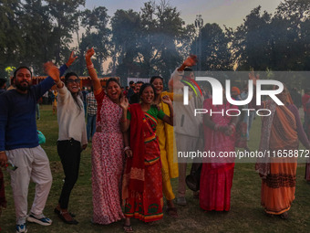 Hindu devotees dance as effigies of the mythic demon king Ravana, his son Meghnath, and brother Kumbhkaran burn on the occasion of the Hindu...