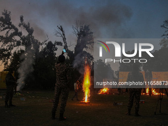 Indian paramilitary soldiers stand as fireworks explode on the occasion of the Hindu festival of Dussehra, which marks the triumph of good o...