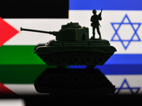 Illustration with figures of a soldier and a tank in front of a Palestine and Israel flags displayed on a computer screen is seen in L'Aquil...