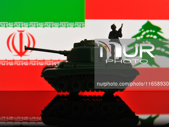 Illustration with figures of a soldier and a tank in front of Iran and Lebanon flags displayed on a computer screen is seen in L'Aquila, Ita...