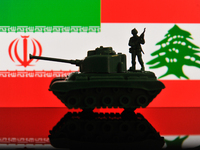 Illustration with figures of a soldier and a tank in front of Iran and Lebanon flags displayed on a computer screen is seen in L'Aquila, Ita...