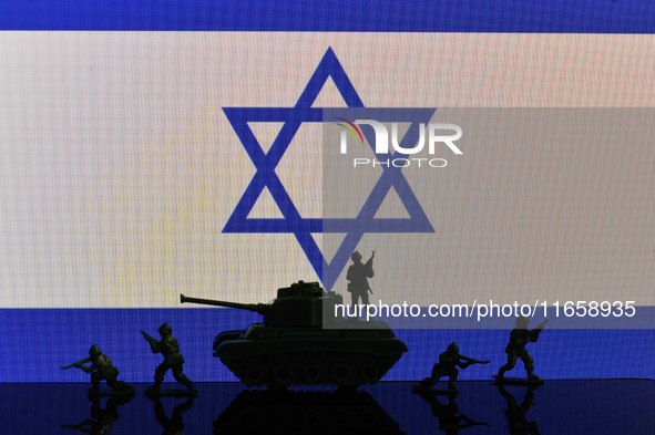 Illustration with figures of soldiers and a tank in front of an Israel flag displayed on a computer screen is seen in L'Aquila, Italy, on Oc...