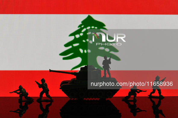 Illustration with figures of soldiers and a tank in front of a Lebanon flag displayed on a computer screen is seen in L'Aquila, Italy, on Oc...