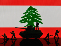 Illustration with figures of soldiers and a tank in front of a Lebanon flag displayed on a computer screen is seen in L'Aquila, Italy, on Oc...