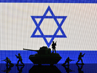 Illustration with figures of soldiers and a tank in front of an Israel flag displayed on a computer screen is seen in L'Aquila, Italy, on Oc...