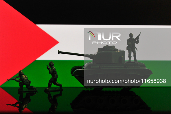 Illustration with figures of soldiers and a tank in front of a Palestine flag displayed on a computer screen is seen in L'Aquila, Italy, on...