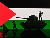 Illustration with figures of soldiers and a tank in front of a Palestine flag displayed on a computer screen is seen in L'Aquila, Italy, on...