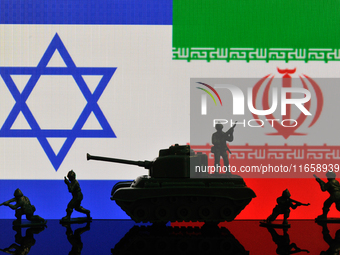 Illustration with figures of soldiers and a tank in front of Israel and Iran flags displayed on a computer screen is seen in L'Aquila, Italy...