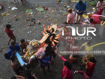 Devotees immerse an idol of the Hindu goddess Durga into the Ganges River on the last day of the Durga Puja festival in Kolkata, India, on O...