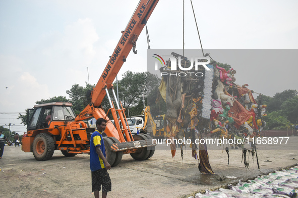 KMC workers clean the banks of the Ganges River on the last day of the Durga Puja festival in Kolkata, India, on October 12, 2024. 